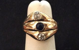 A gold ring with three stones