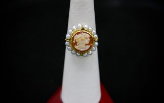 A ring with a woman's portrait on the centerpiece