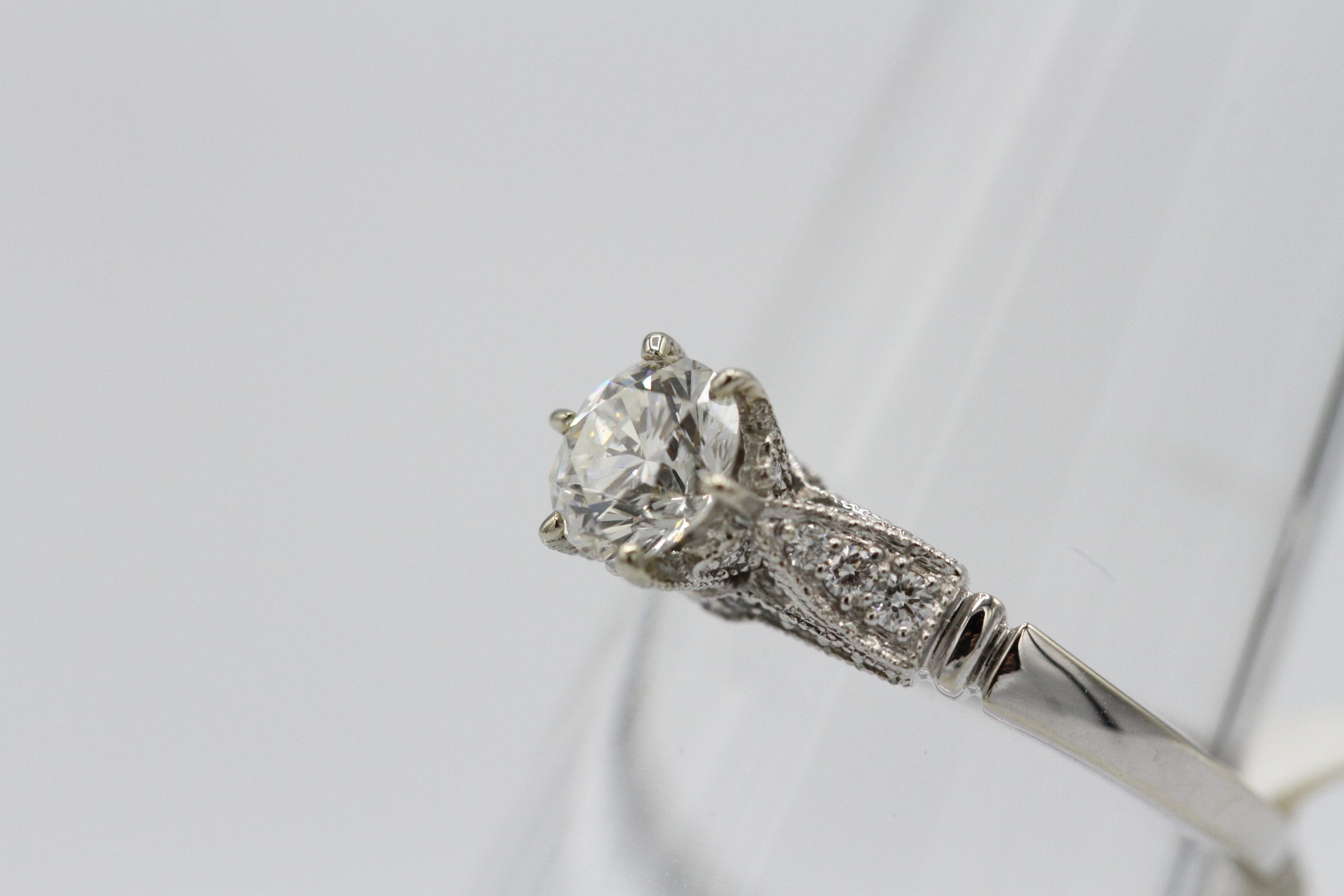 A large silver ring with a large diamond stone