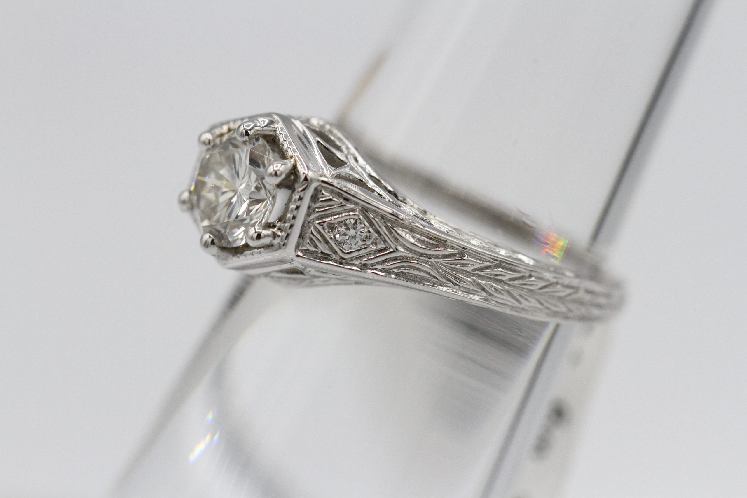 A large silver ring with a large diamond centerpiece