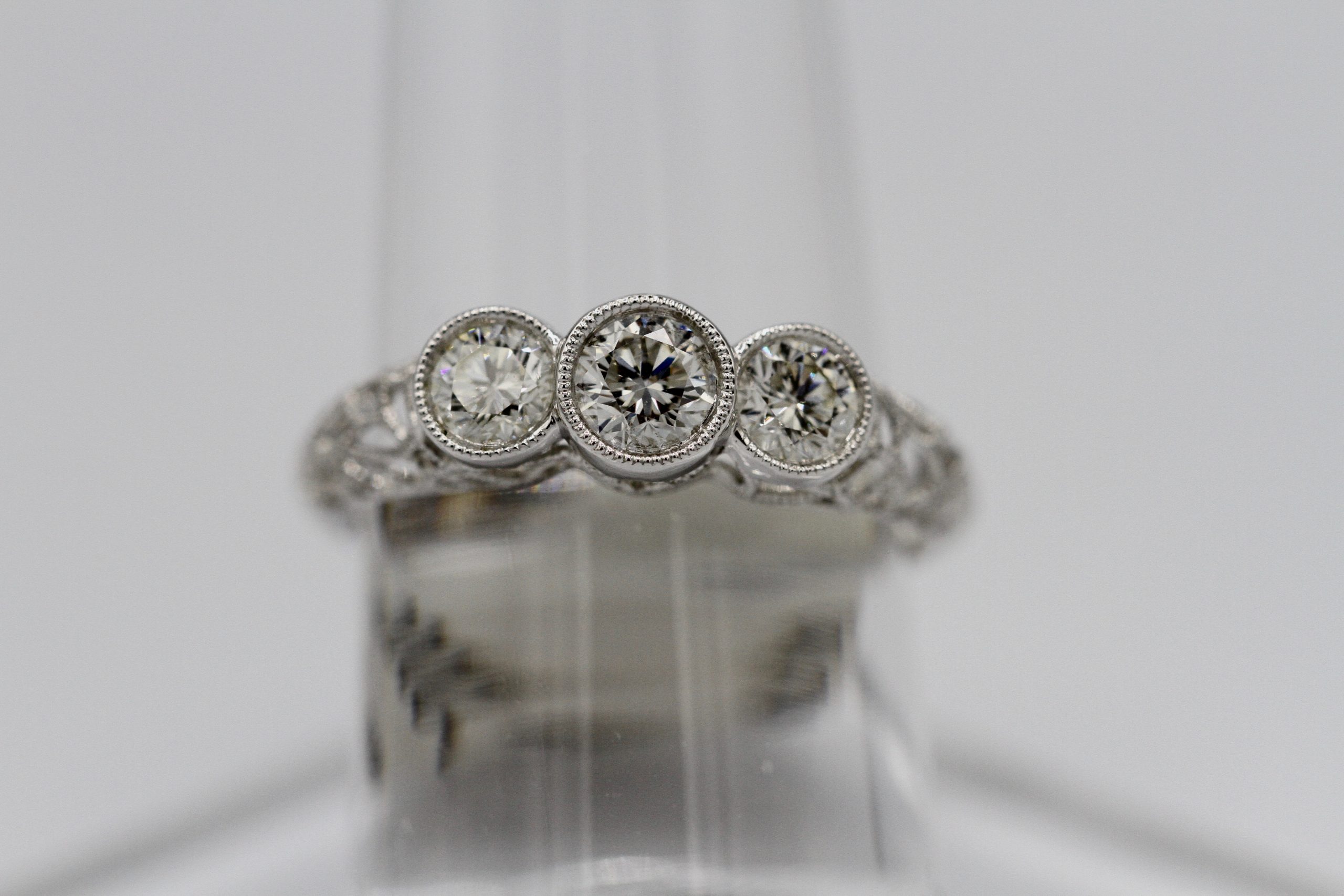 A silver ring with three large diamonds