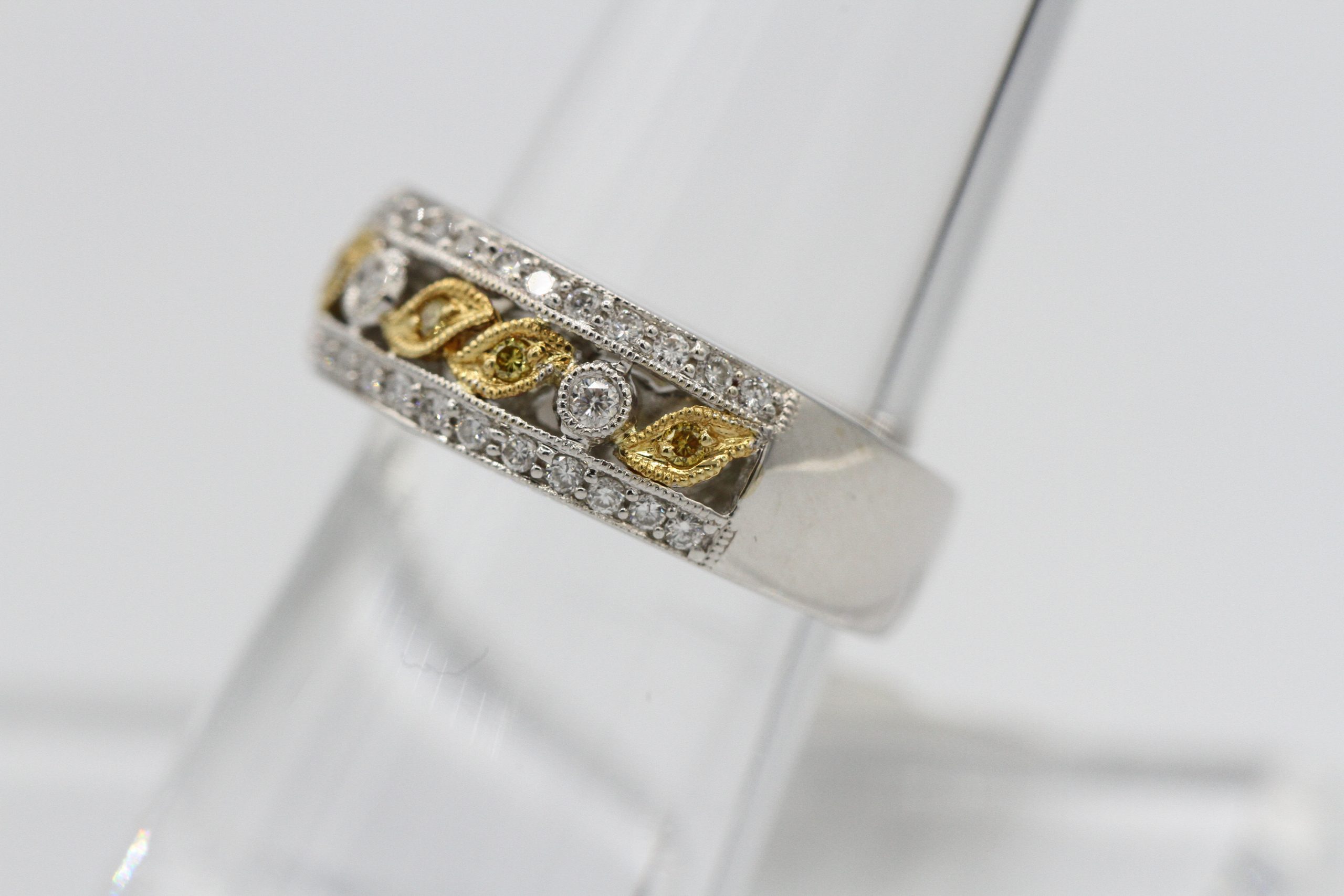 A silver ring with gold and diamond ring