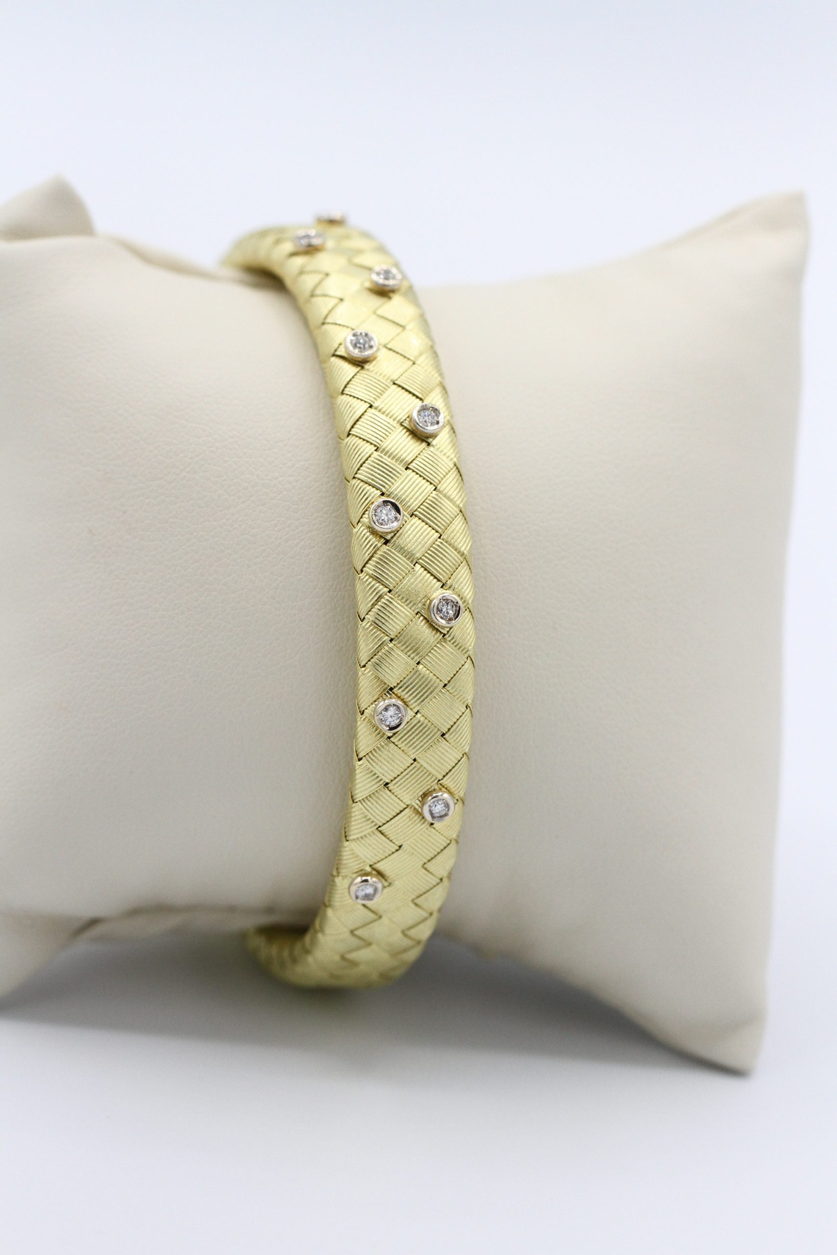 A gold bracelet with inlaid diamonds