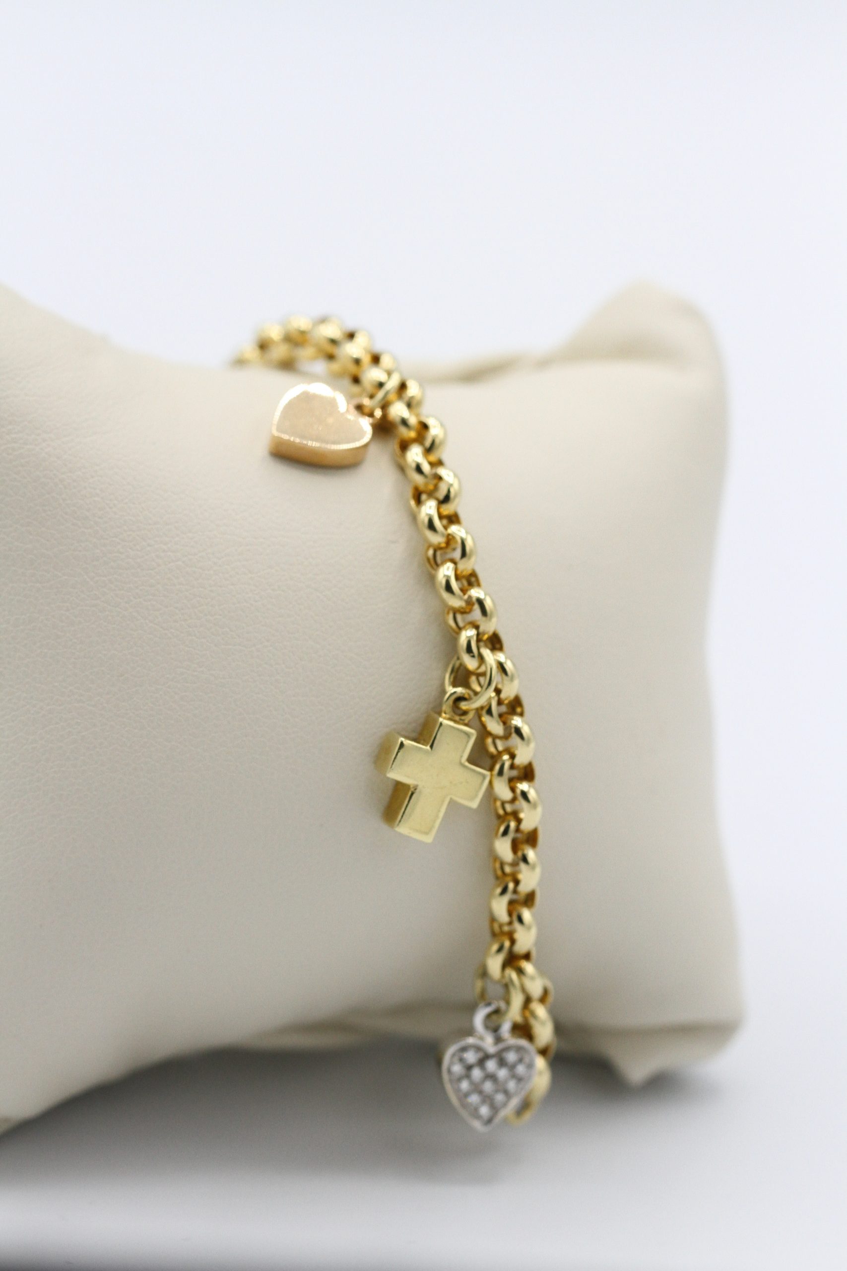 A gold bracelet with pendents dangling from it.