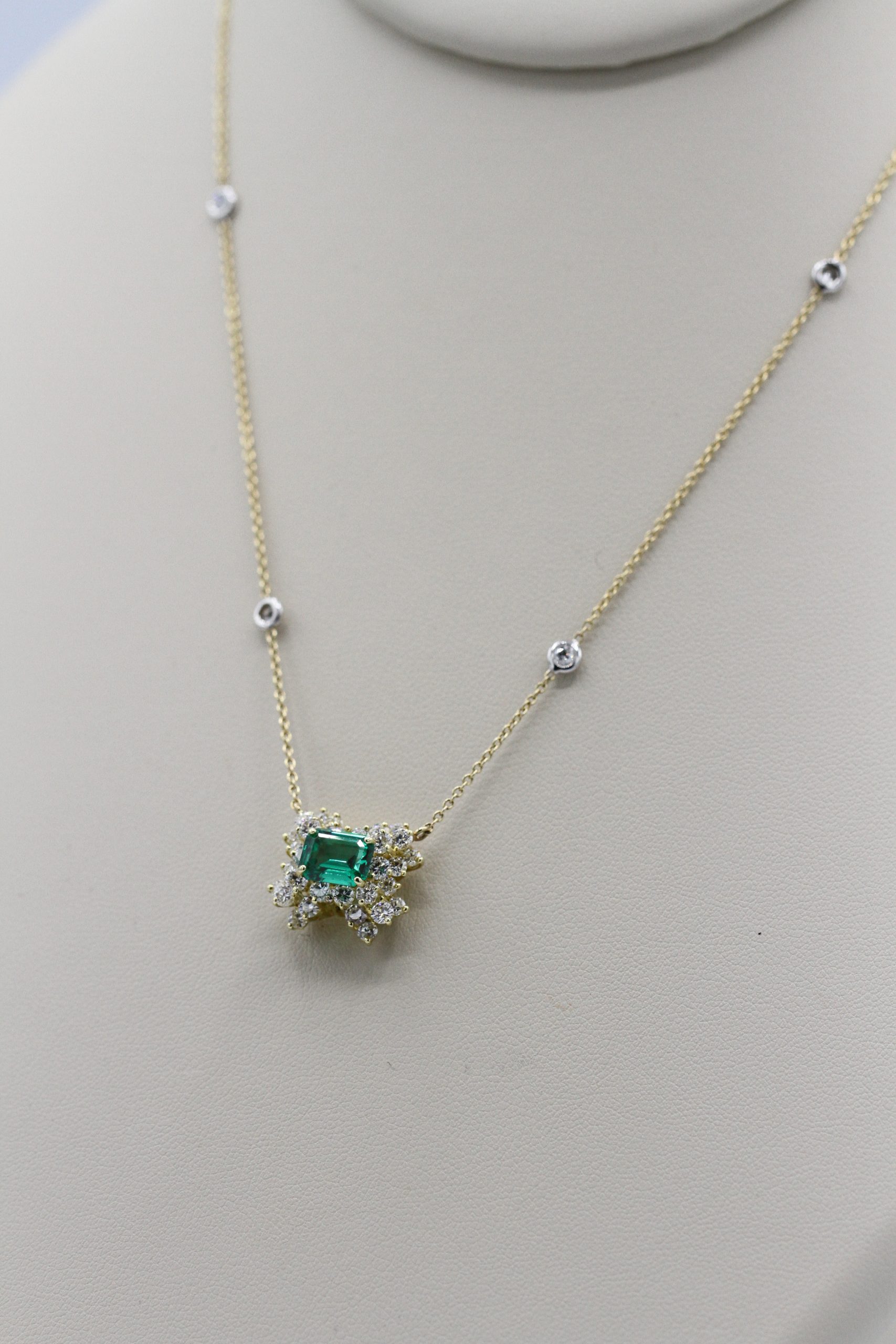 An ornate gold, emerald, and diamond necklace