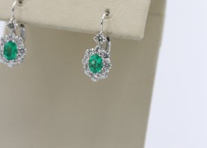 silver earrings with emerald centerpieces.