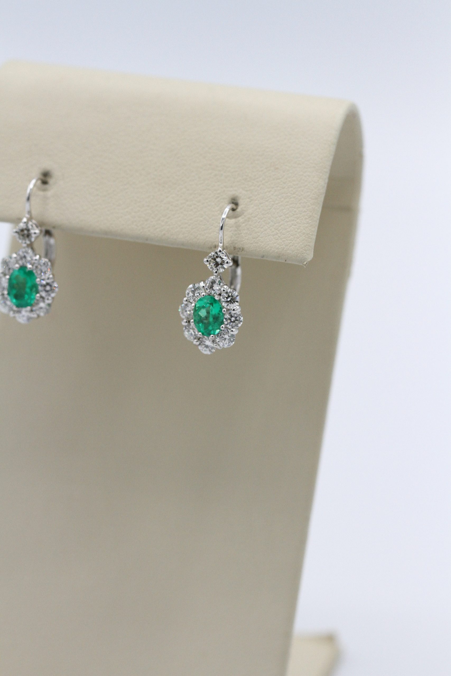 silver earrings with emerald centerpieces.
