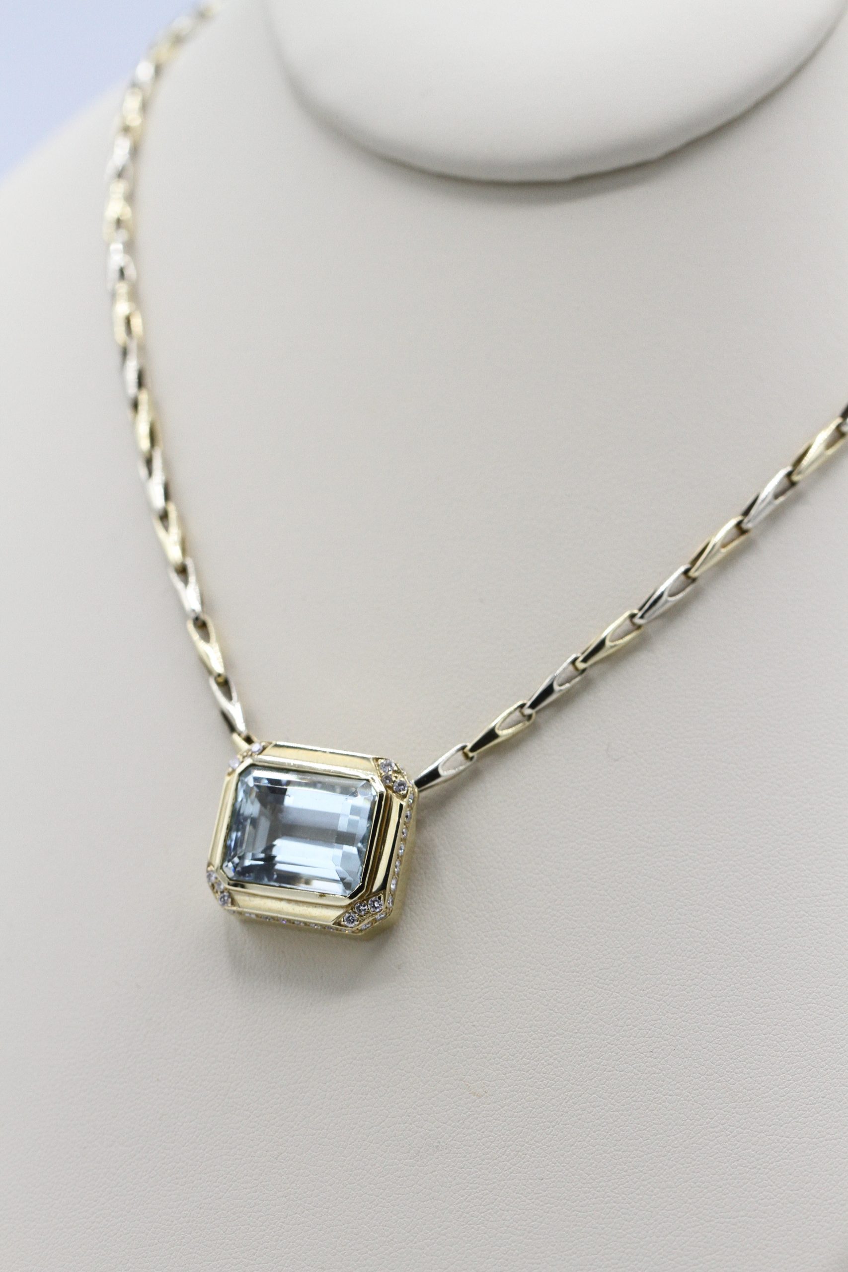 A necklace with a large, square large centerpiece