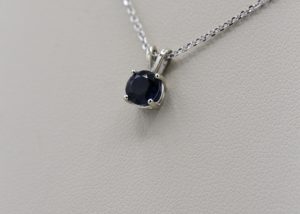 A necklace with a small, dark blue stone