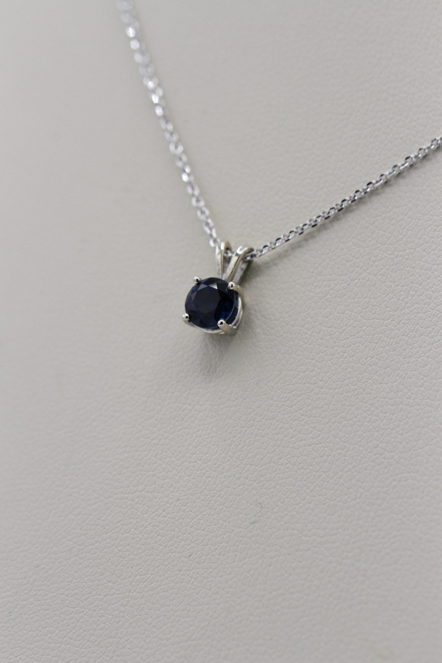 A necklace with a small, dark blue stone