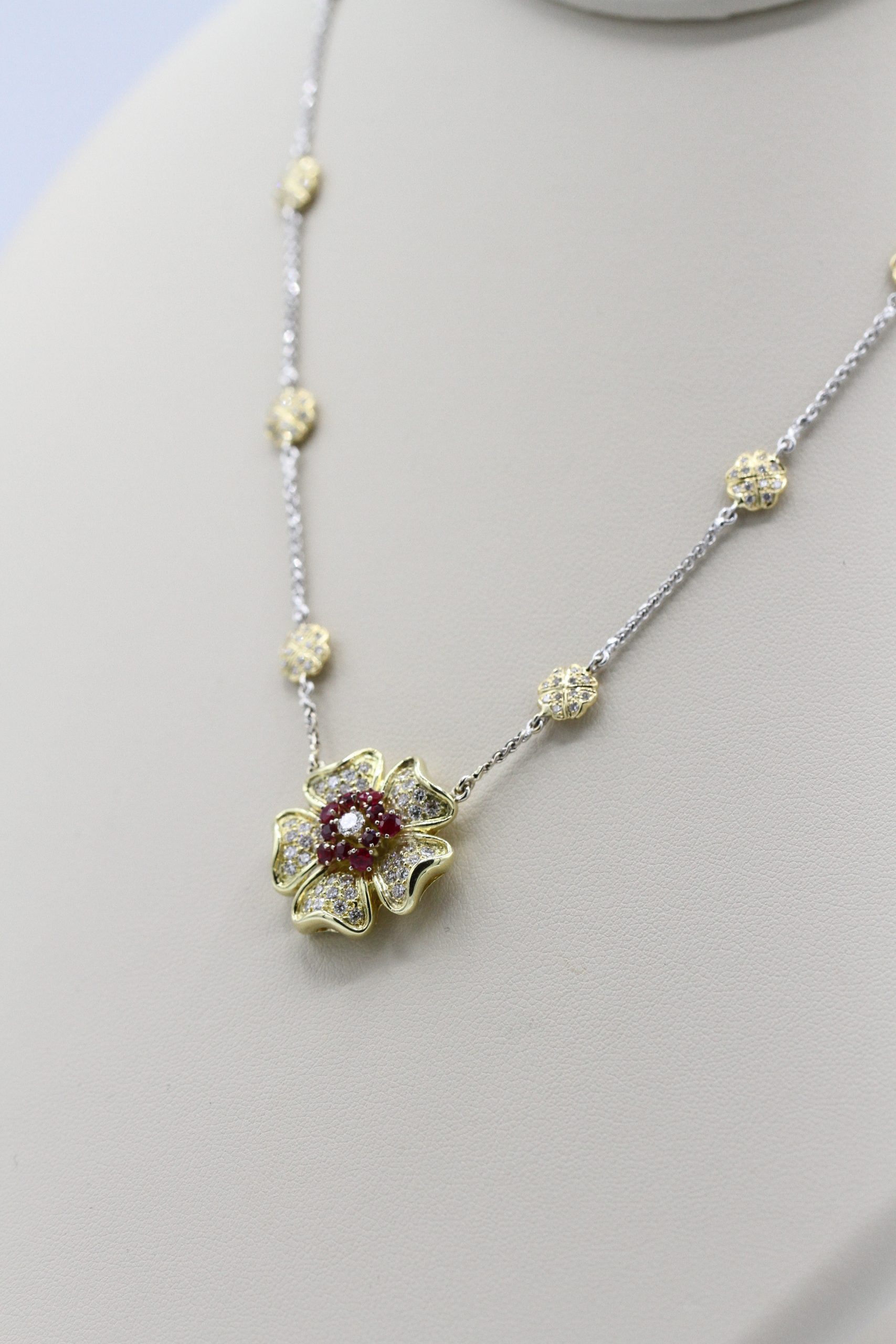 A necklace in the shape of a clover with red stones
