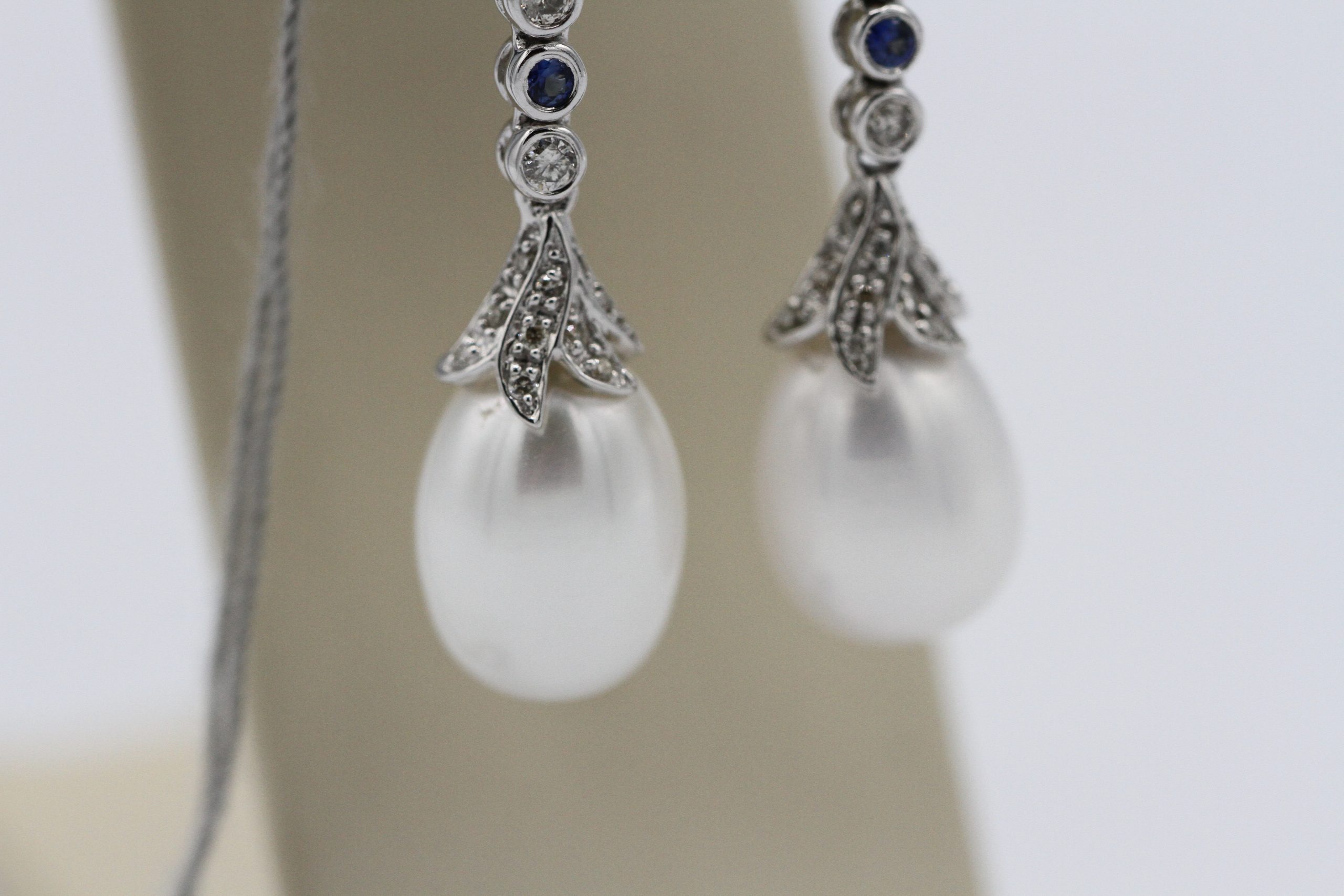 A closeup of some pearl earrings for sale